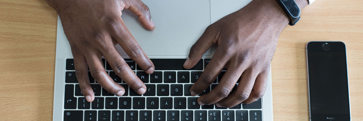 Hands typing on a keyboard.